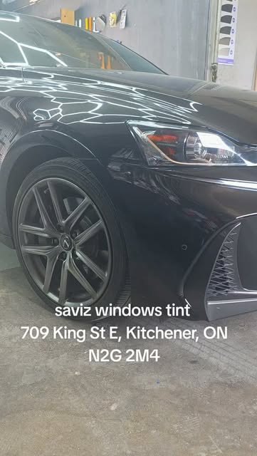 Front quarter view of a tinted black sedan